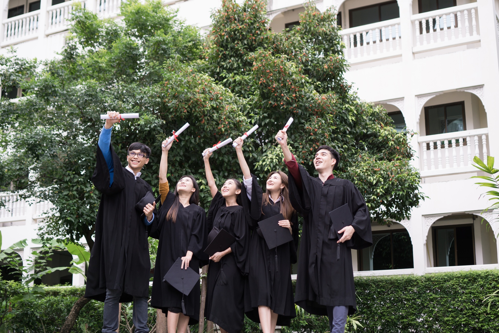 Group of Diverse International Graduating Students Celebrating Success, Education goal concept.